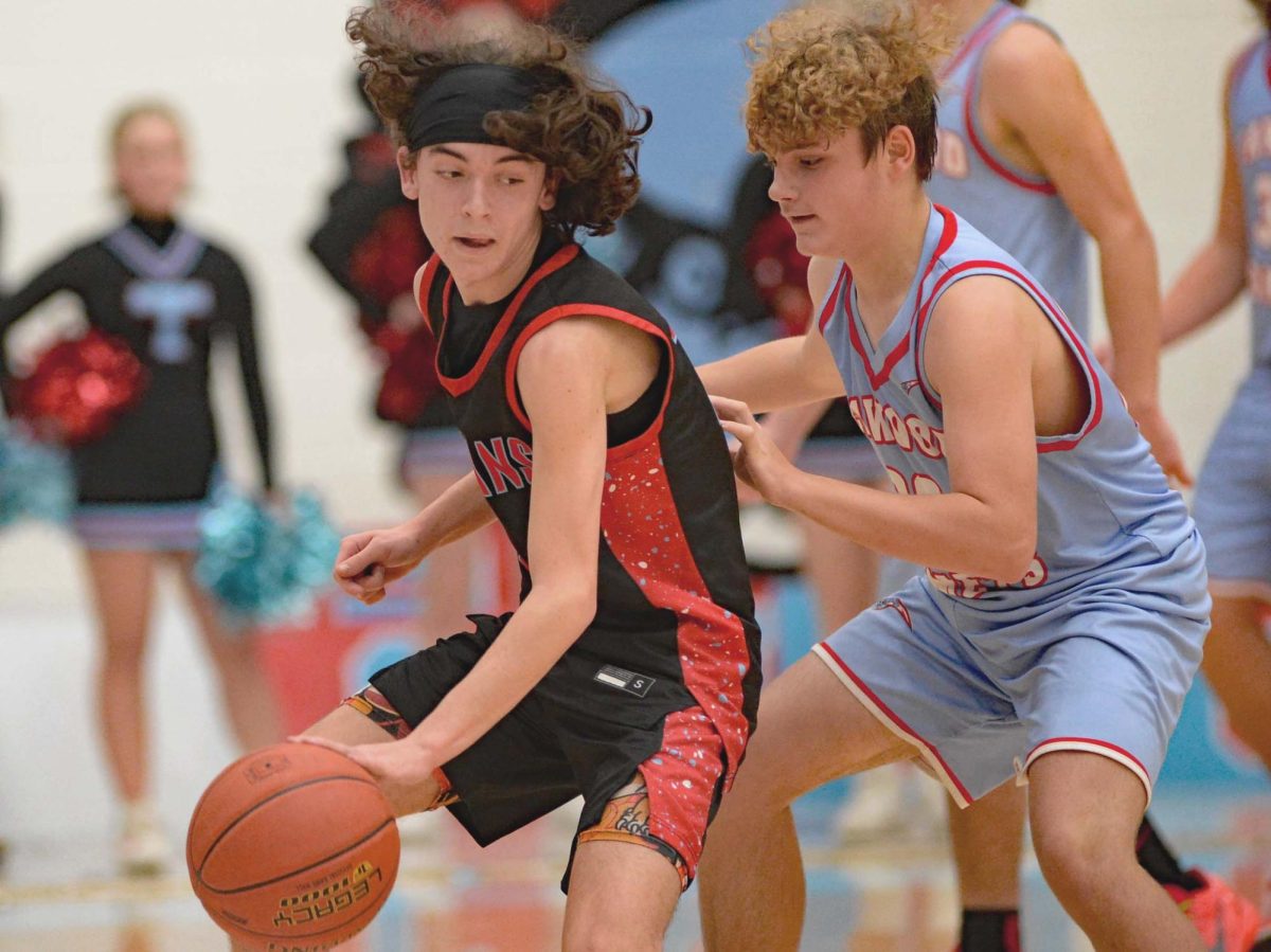 James A. Cawood guard Kaden Jones looked for an opening against Cawoods Jaxton Miler on Thursday. Jones scored 16 points in the Trojans 46-36 win.