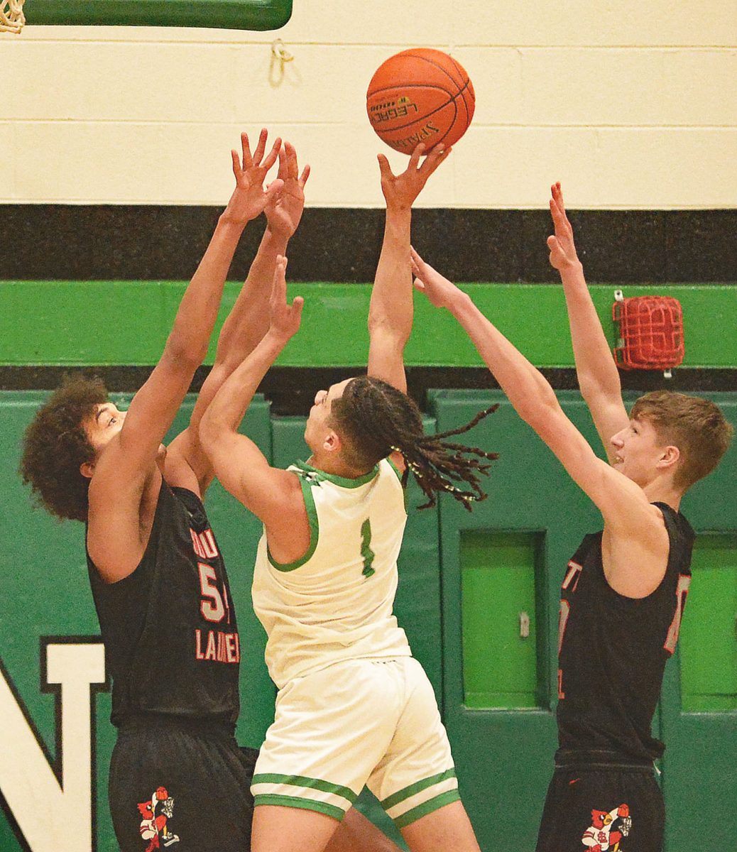 Harlan guard Kyler McLendon put up a shot over South Laurels Jordan Mabe in Tuesdays 13th Region clash. McLendon scored 34 points to lead the Dragons. Mabe scored 19 to lead the Cardinals to a 75-60 win.