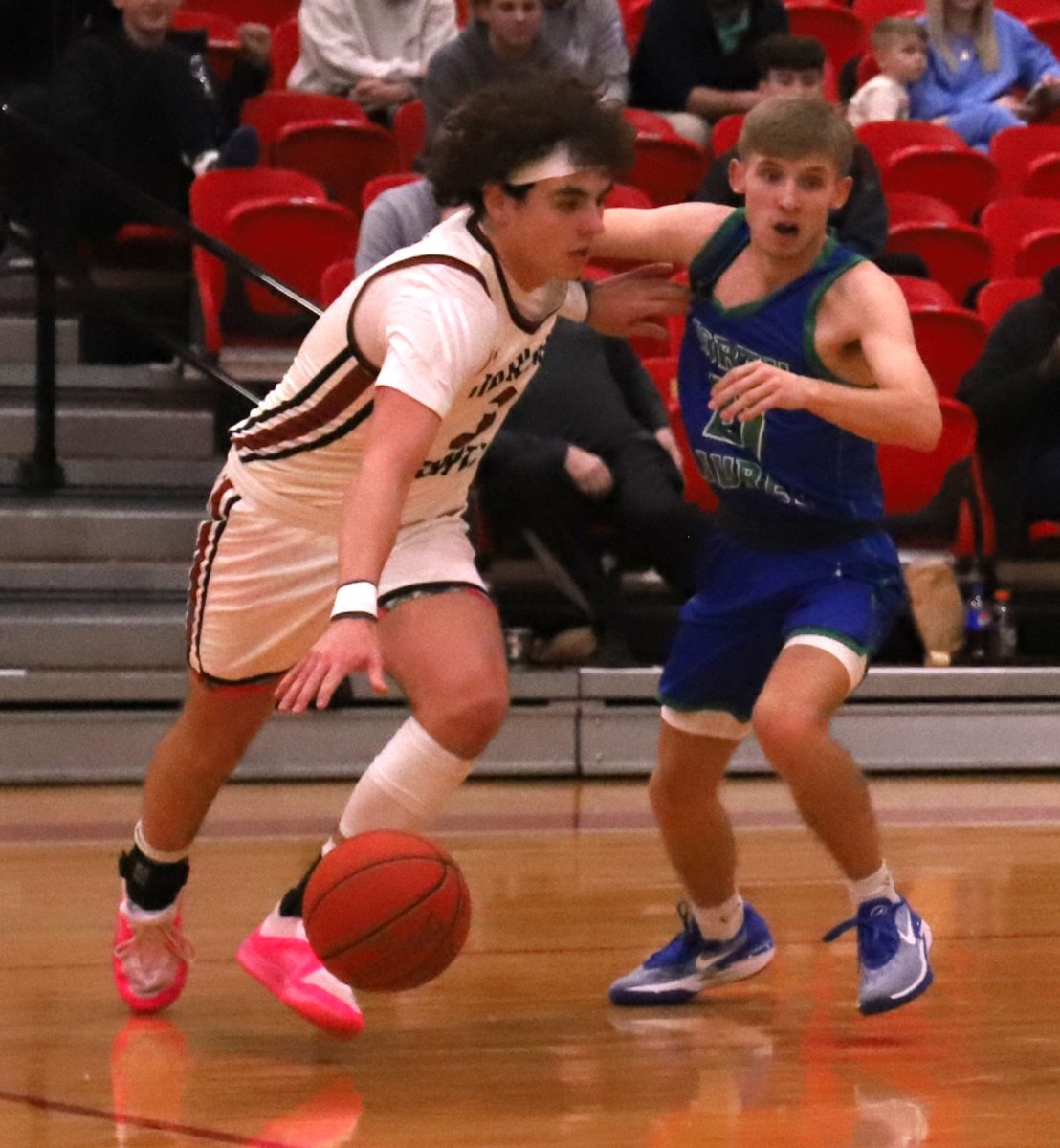 Harlan County guard Maddox Huff worked around a North Laurel defender in Saturdays game at Corbin. Huff scored 16 points in the Bears 65-58 victory.