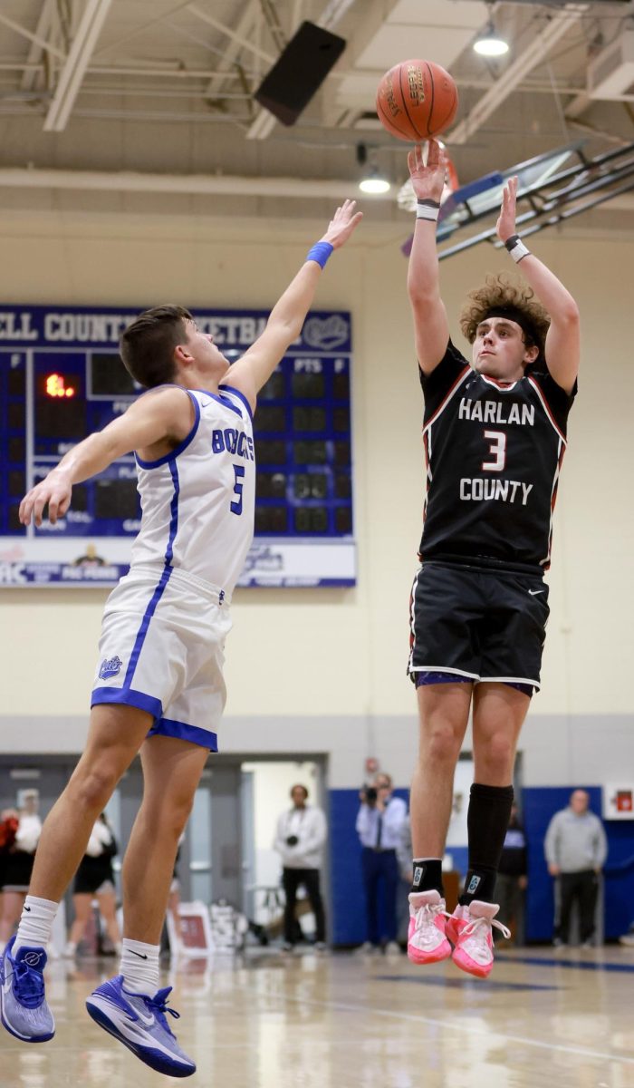 Harlan County guard Maddox Huff put up a shot over Bell Countys Blake Burnett in Tuesdays district clash. Huff scored 11 points in the Bears 71-52 victory.