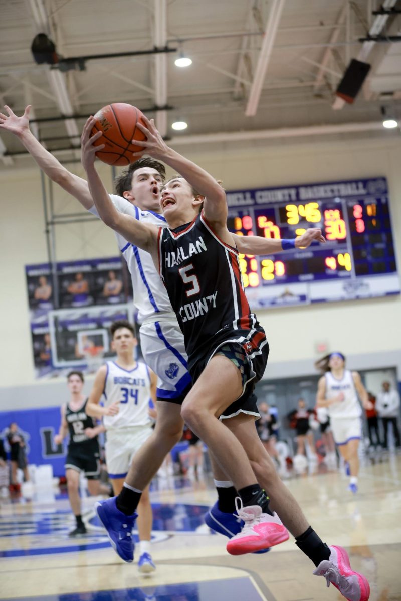 Harlan County sophomore Brennan Blevins drew a foul as he went to the basket in district action Tuesday at Bell County.