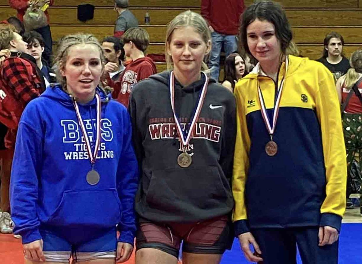 Victoria Day (center) was the winner in the 128-pound division in the Southeastern Kentucky Conference wrestling meet.