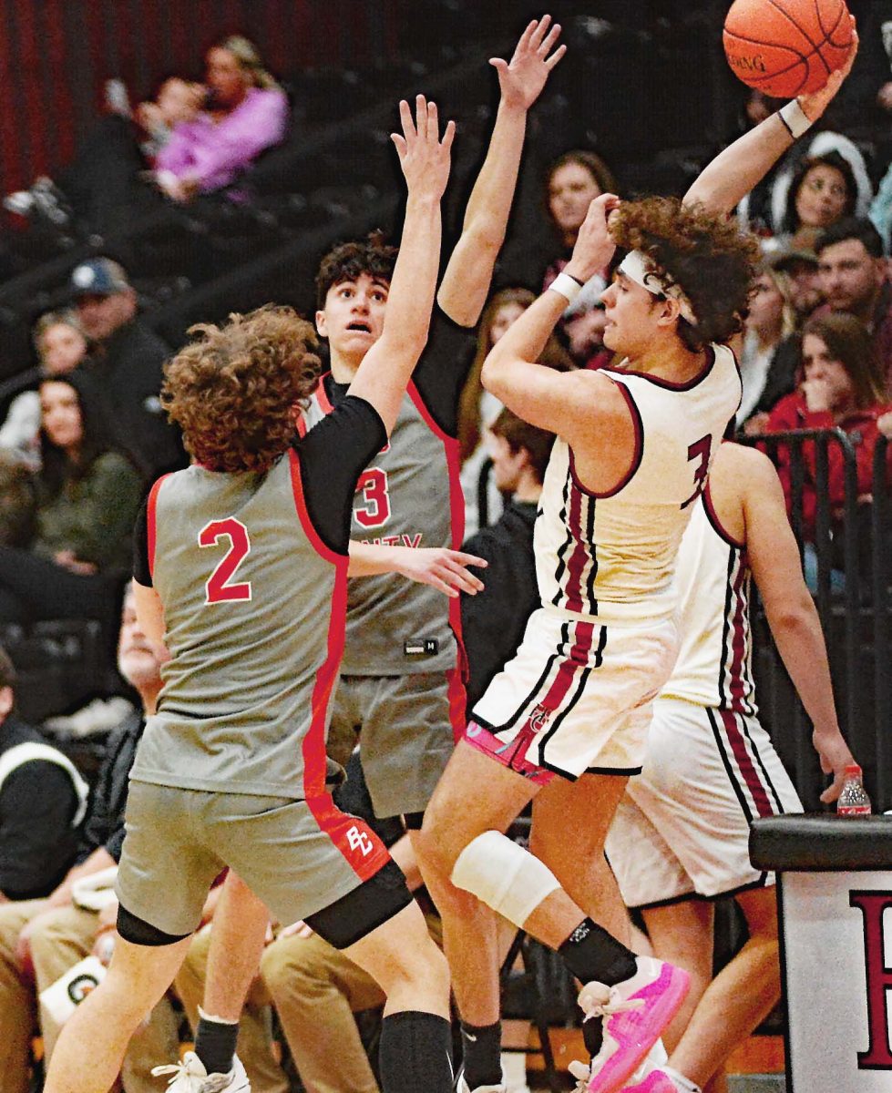 Harlan County guard Maddox Huff made a pass as Boyd Countys Jacob Spurlock and Jason Ellis moved in during Saturdays game. Huff scored 16 points in the Bears 93-75 win.