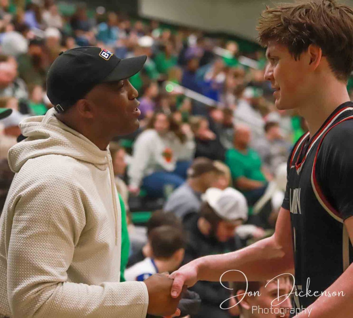 Former Harlan all-state guard Charles Thomas greeted Harlan County all-state guard Trent Noah in a game at Harlan earlier this month. Noah broke Thomas county scoring record on Saturday against Boyd County with 38 points. He now has 3,375 points in his prep career.