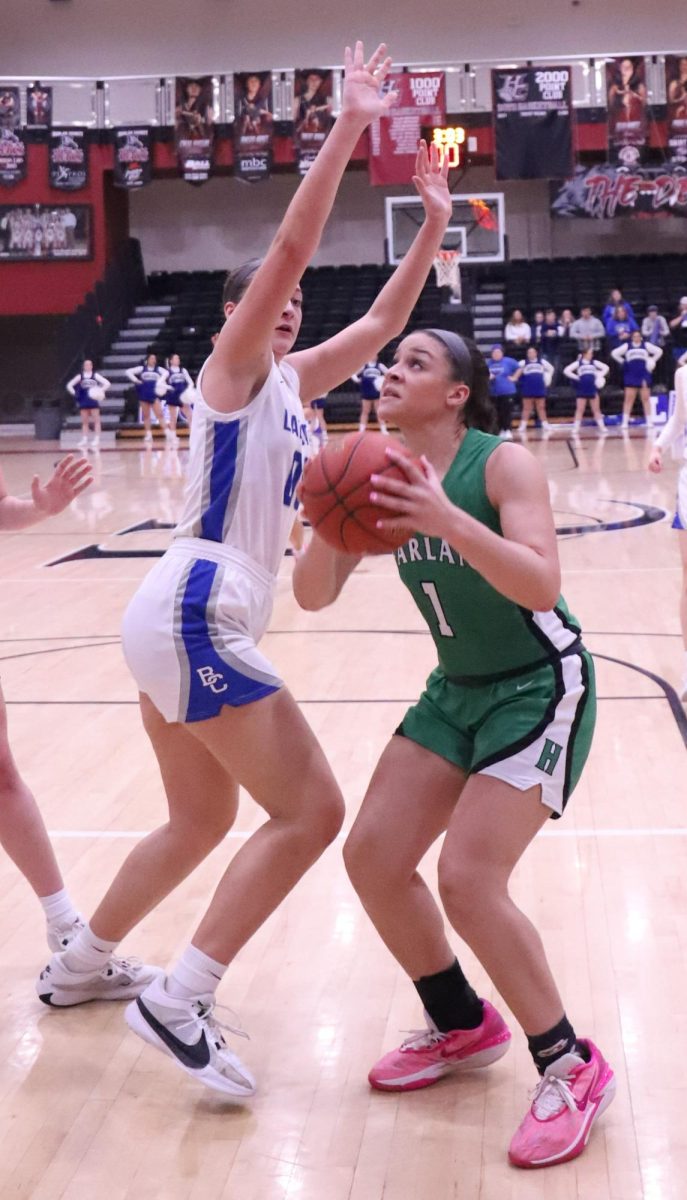 Harlan forward Kylie Noe worked against Bell County center Kairi Lamb during the 52nd District Tournament finals Thursday. Lamb had 17 points and eight rebounds in Bells 60-54 victory.