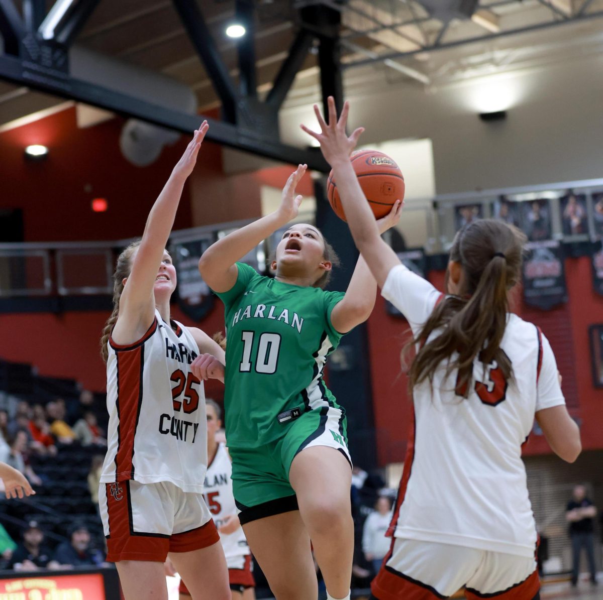 Harlan guard Peyshaunce Wynn worked between Cheyenne Rhymer and Jaylee Cochran for a shot in 52nd District Tournament action. The Lady Dragons advanced to the finals with a 57-55 win over Harlan County.