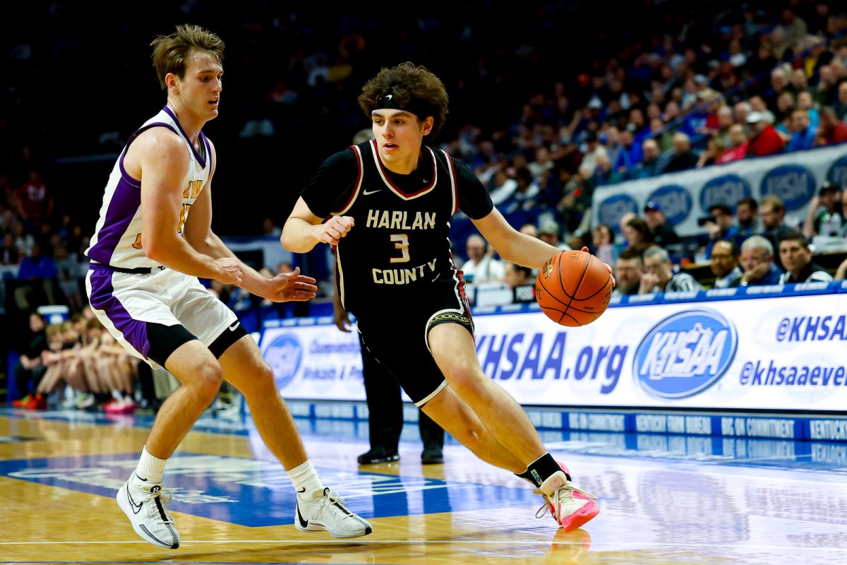 Harlan County guard Maddox Huff worked toward the basket as Lyon Countys Travis Perry defendied during the state championship game Saturday at Rupp Arena. Huff scored 22 to lead the Bears, who finished the season with a 34-5 record. Perry paced the Lyons with 27 points,.