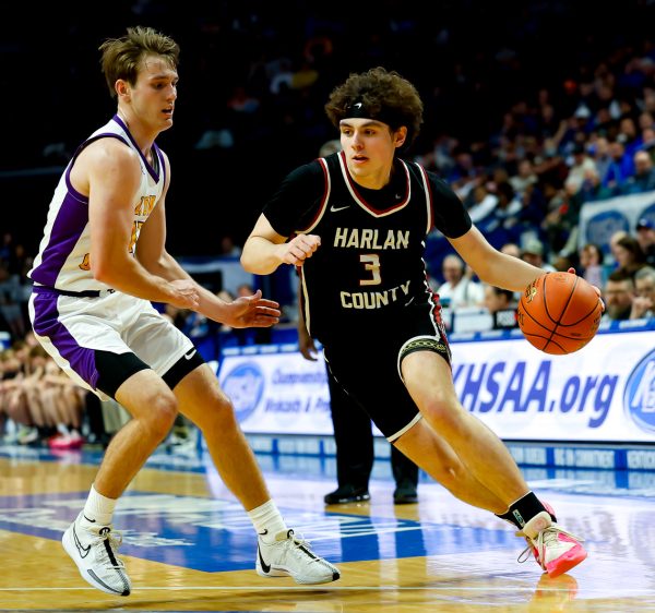 Harlan County guard Maddox Huff worked toward the basket as Lyon Countys Travis Perry defendied during the state championship game Saturday at Rupp Arena. Huff scored 22 to lead the Bears, who finished the season with a 34-5 record. Perry paced the Lyons with 27 points,.
