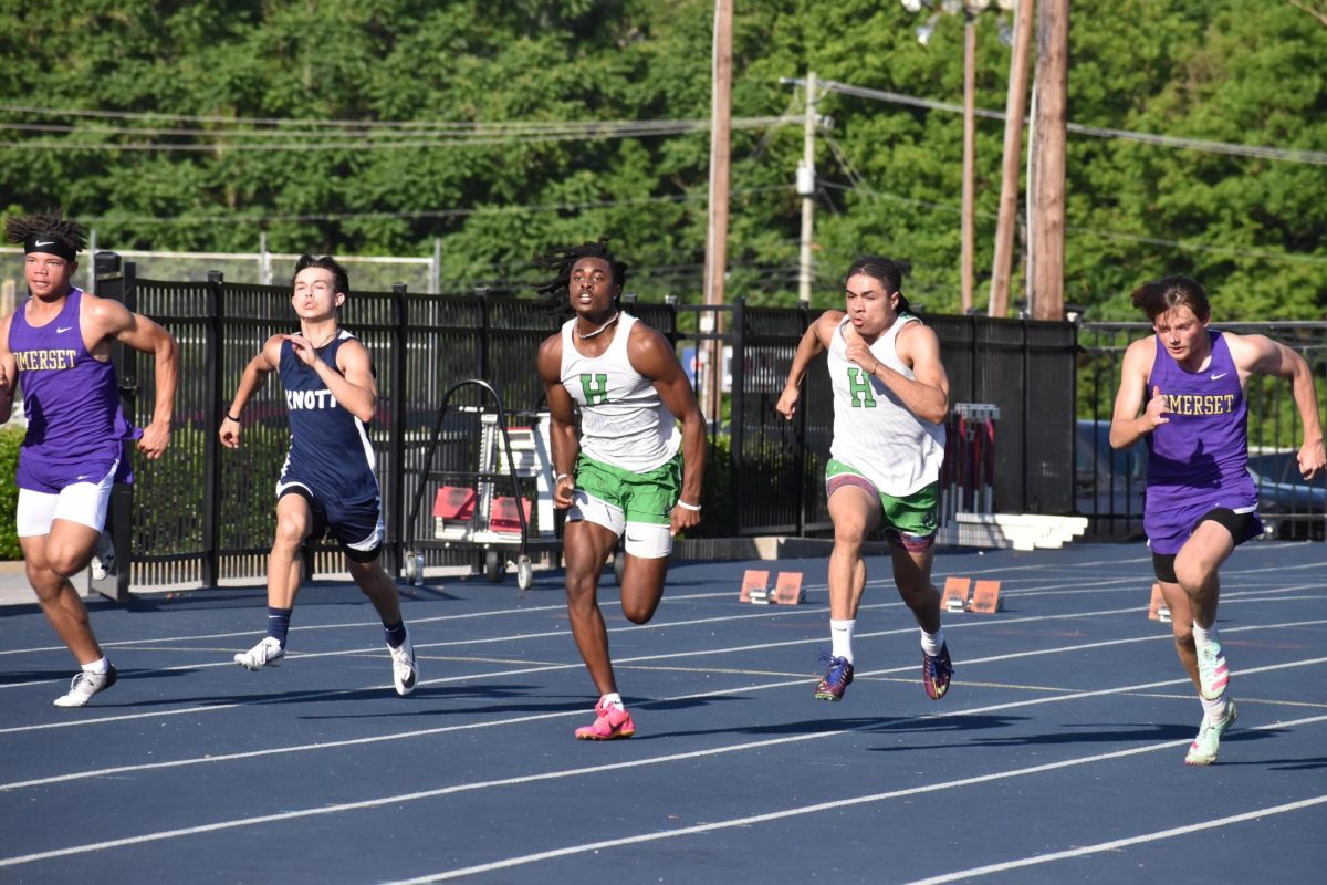 Harlans Darius Akal (middle) and Kyler McLendon (second from left) were each winners in the Region 6 meet on Tuesday as the Green Dragons placed second in the team competition.
