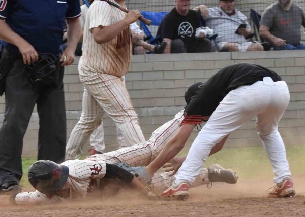 Harlan County second baseman Aiden Craig slid home with a run in the Black Bears’ 8-6 win Tuesday over visiting Perry Central.