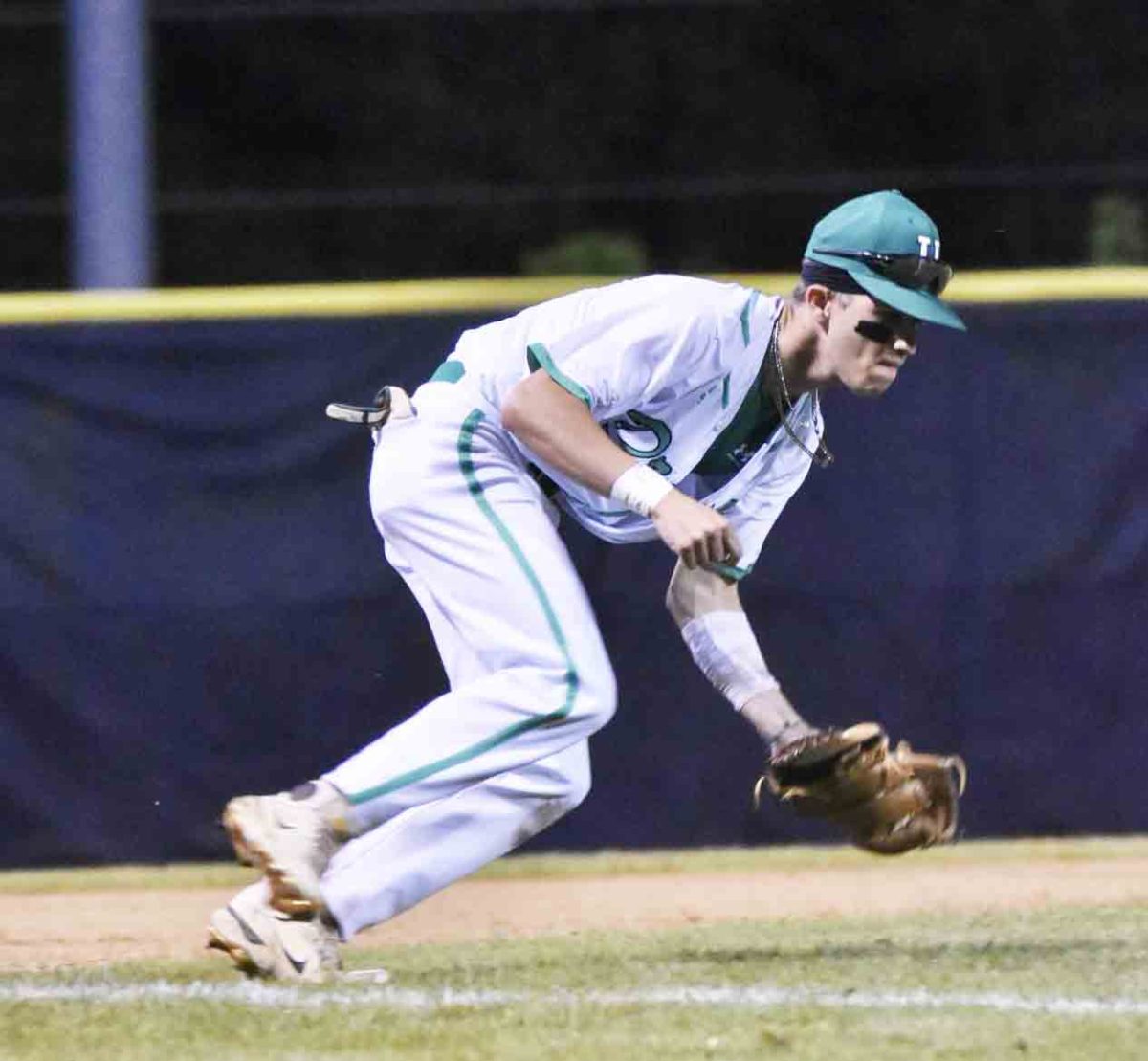 Harlan infielder Jake Brewer made a play on defense during the Dragons' 12-8 win over Barbourville in the 13th Region Tournament.