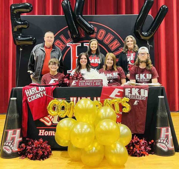 Harlan County High School senior Heaven Hensley signed with Eastern Kentucky University on Tuesday to continue her academic and cheerleading career. Pictured with Hensley are, from left, front row: Hunter Stevens, Tara Dewees and Cody Dewees; back row: HCHS athletic director Eugene Farmer, HCHS cheer coach Taylor Fields and HCHS Principal Kathy Napier.