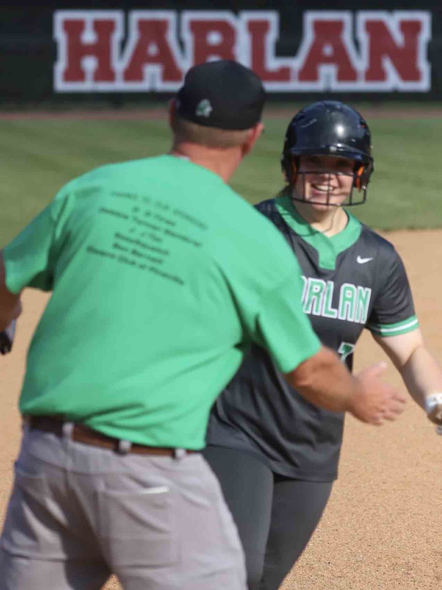 Harlan+first+baseman+Abbi+Fields+was+congratulated+by+coach+David+Overbay+after+her+two-run+homer+in+the+second+inning+Tuesday+in+the+Lady+Dragons+4-3+win+over+Harlan+County.+Fields+hit+three+home+runs+in+the+tournament+to+win+most+valuable+player+honors.
