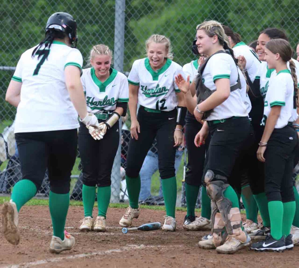 Harlans Abbi Fields was greeted at the plate after her sixth-inning homer in the Lady Dragons 12-8 win over Harlan County.