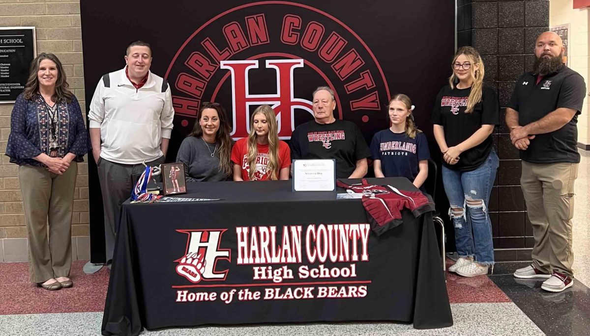 Victoria Day became the first Harlan County High School student to sign with a college in wrestling as she signed with the University of the Cumberlands on Thursday in a ceremony at the school. Pictured with Day, from left, are HCHS Principal Kathy Napier, athletic director Eugene Farmer, Lesley Bryant, Carl Bennett, Holly Wright, Emily Bryant and Blake Johnson.