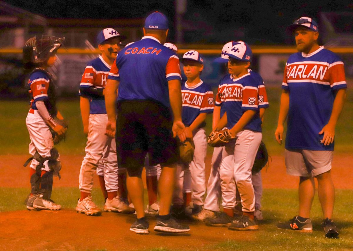 The Harlan All Stars listened as coach Anthony Nolan provided directions in District 4 action Sunday. Harlan will play Knox County on Tuesday after an 11-1 win over Tri City.
