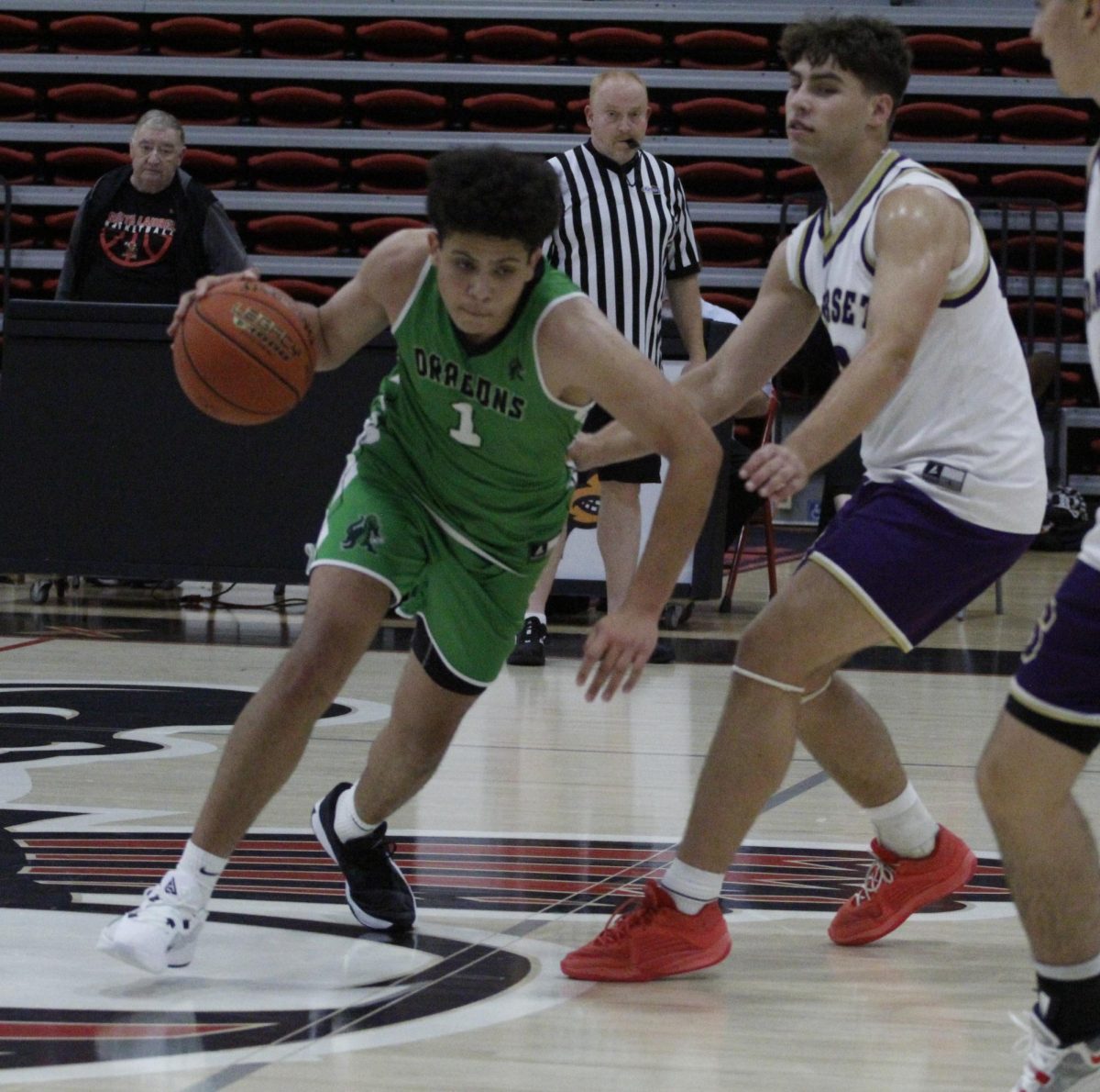 Harlans Kobe Noe worked around a Somerset defender in scrimmage action Friday, Noe scored 14 points in the Dragons 72-44 loss.