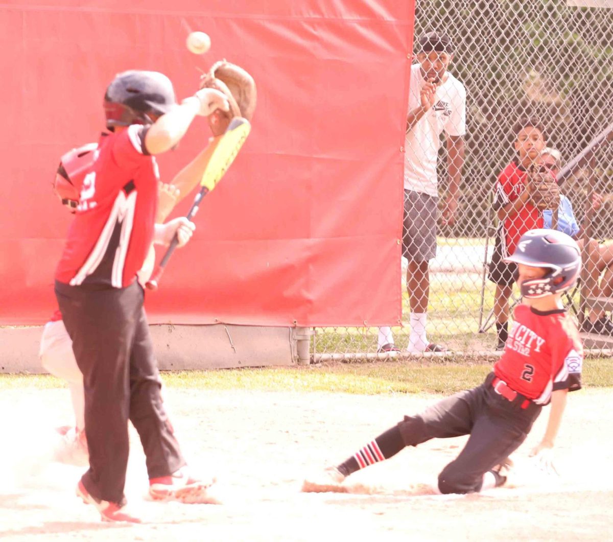 Tri Citys Truett Baldwin slid home with a run after a wild pitch in District 4 East Tournament (ages 9-10) action Sunday. Tri City advanced with a 13-10 victory.