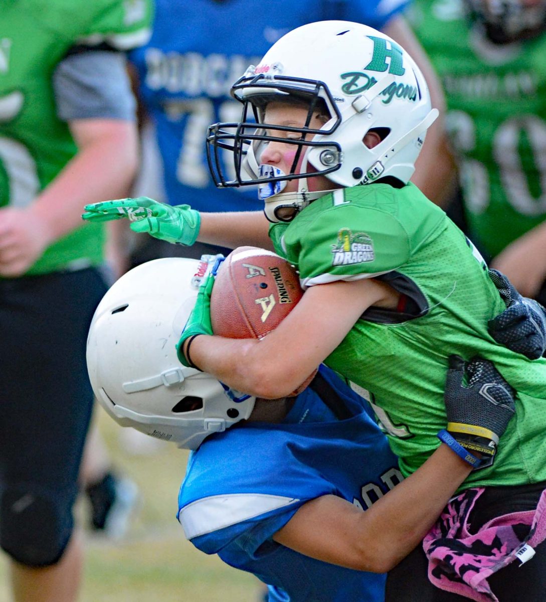 Harlan running back Judah Shope battled for yardage in last week's fifth- and sixth-grade football game against Bell County. The Dragons fell 12-6. Kolbi Green scored for Harlan on a 70-yard run.