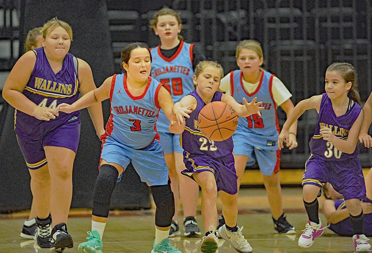 Pasleigh Asher, of Wallins, and Leah Collins, of James A. Cawood, battled for a loose ball in scrimmage action Friday at Harlan County High School in the fifth- and sixth-grade county panorama. 