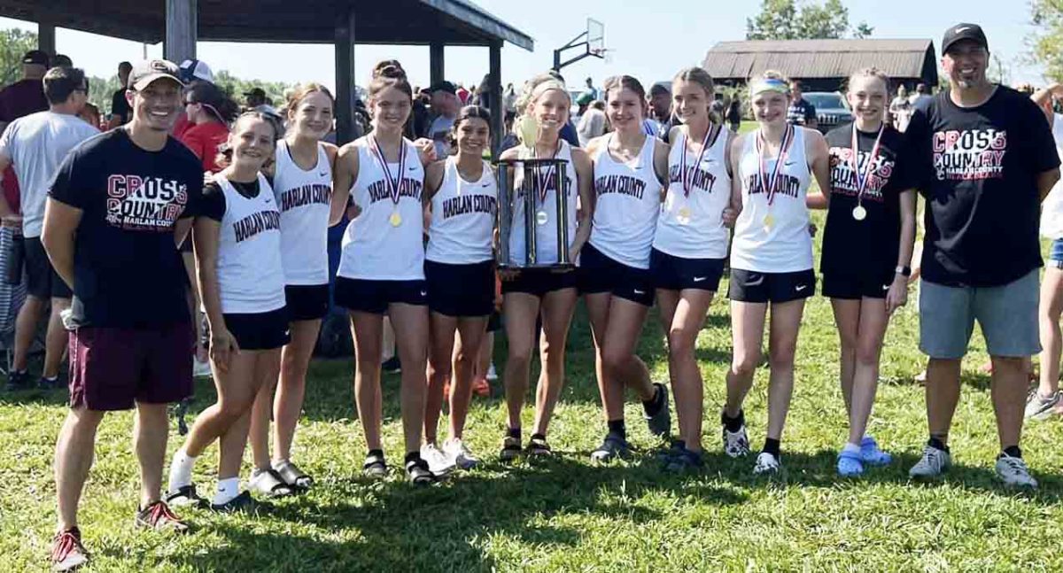 The Harlan County High School girls took first in the season-opening meet at Lynn Camp. Team members include, from left: assistant coach Jacob Carroll, Suzy Mumford, Jaycee Simpson, Preslee Hensley, Aliyah Deleon, Peyton Lunsford,  Maddi Daniels, Lauren Lewis, Gracie Roberts, Kiera Roberts and coach Ryan Vitatoe.