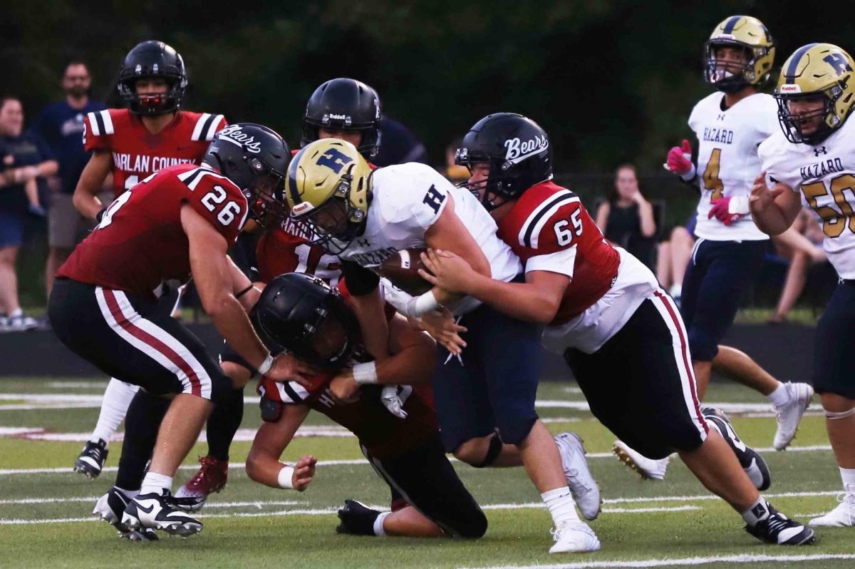 Harlan County lineman Cooper Blevins and linebacker James Ryan Howard battled to bring down a Hazard ball carrier in Friday's game. The Bulldogs improved to 2-0 with a 33-0 victory.