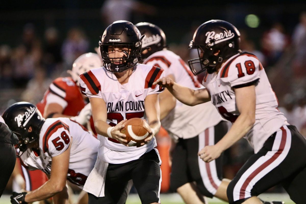 Harlan County freshman quarterback Brayden Morris handed the ball off to Isaiah Cornett in Friday's game. Morris scored two touchdowns in the Bears' 28-22 loss.