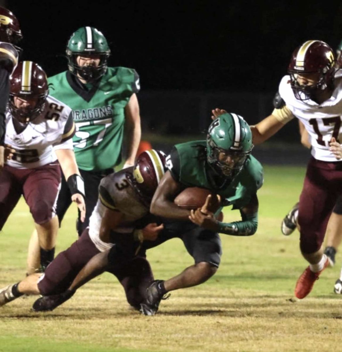 Harlan's Darius Akal was brought down by Pineville's Kaiden Robbins in Friday's district clash. Akal scored four touchdowns in the Dragons' 38-14 win.