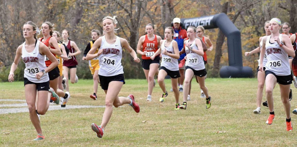 Harlan County senior Peyton Lunsford (204) raced toward the finish line on her way to the Region 7 championship in her final race at the HCHS course.