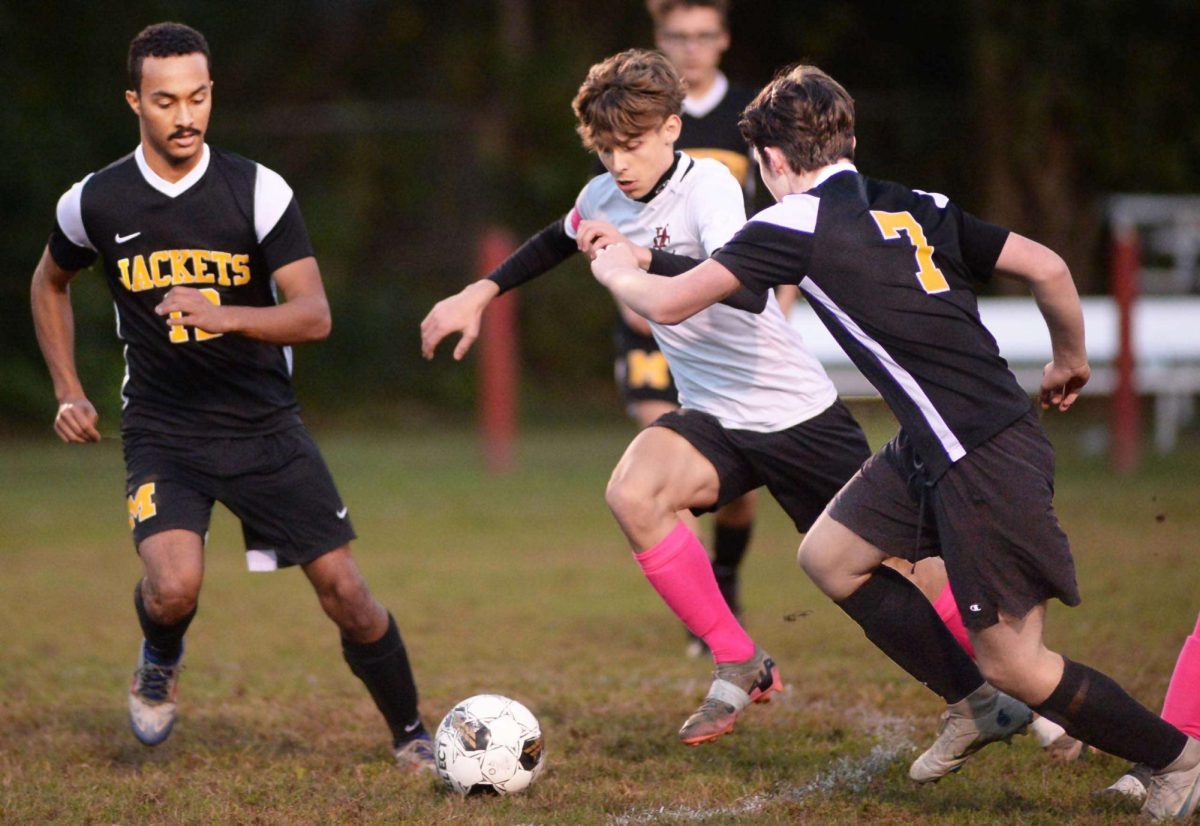 Middlesboro defenders Aiden Spencer (12) and Joseph Craig (7) converged on Harlan County's Bradley Brock during the 50th District championship game at the James A. Cawood field. Both teams bowed out of the 13th Region Tournament Monday night at North Laurel.