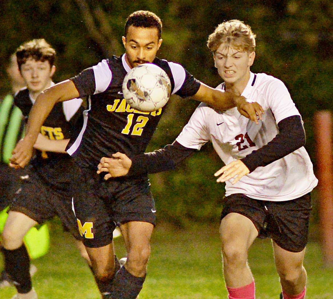 Harlan County sophomore Luther Gross battled for the ball against Middlesboro junior Aiden Spencer during Tuesday night's 50th District championship game at the James A. Cawood field. The Black Bears prevailed 2-1, securing their fourth straight district title.