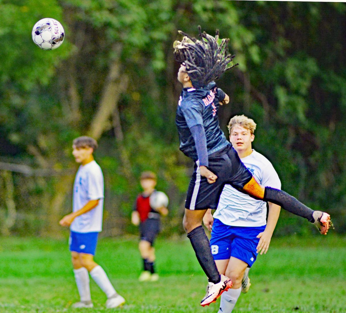 Harlan County midfielder Ray Splawn elevated over the turf for a header to a trailing Black Bear during the Bears’ win Monday over Barbourville.
