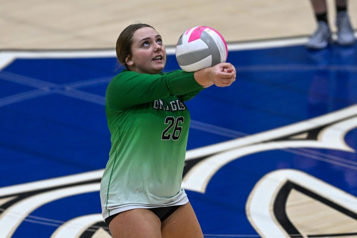 Harlan’s Gracie Hensley set the ball in action from the 52nd District Tournament on Monday.