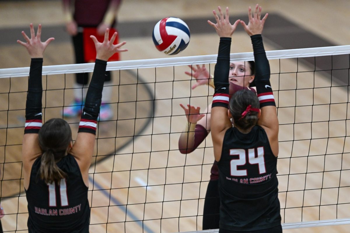 Harlan County's Kylee Hoiska (11) and Madilynn Nolan went to the net for a block in Monday's match at Pineville. The Lady Bears won in five sets to improve to 19-5 on the season.