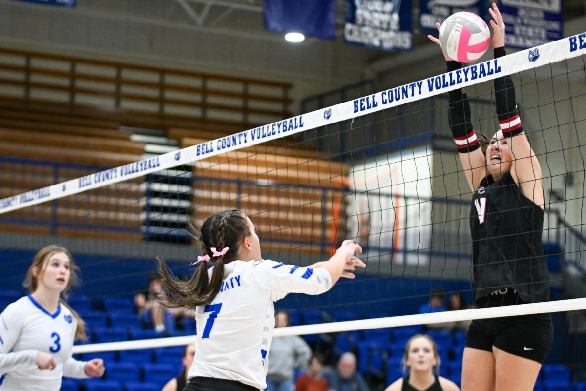 Harlan County's Kylee Hoiska went to the net for a point in the 52nd District Tournament finals Tuesday. Hoiska earned most valuable player honors as Harlan County won in four sets.