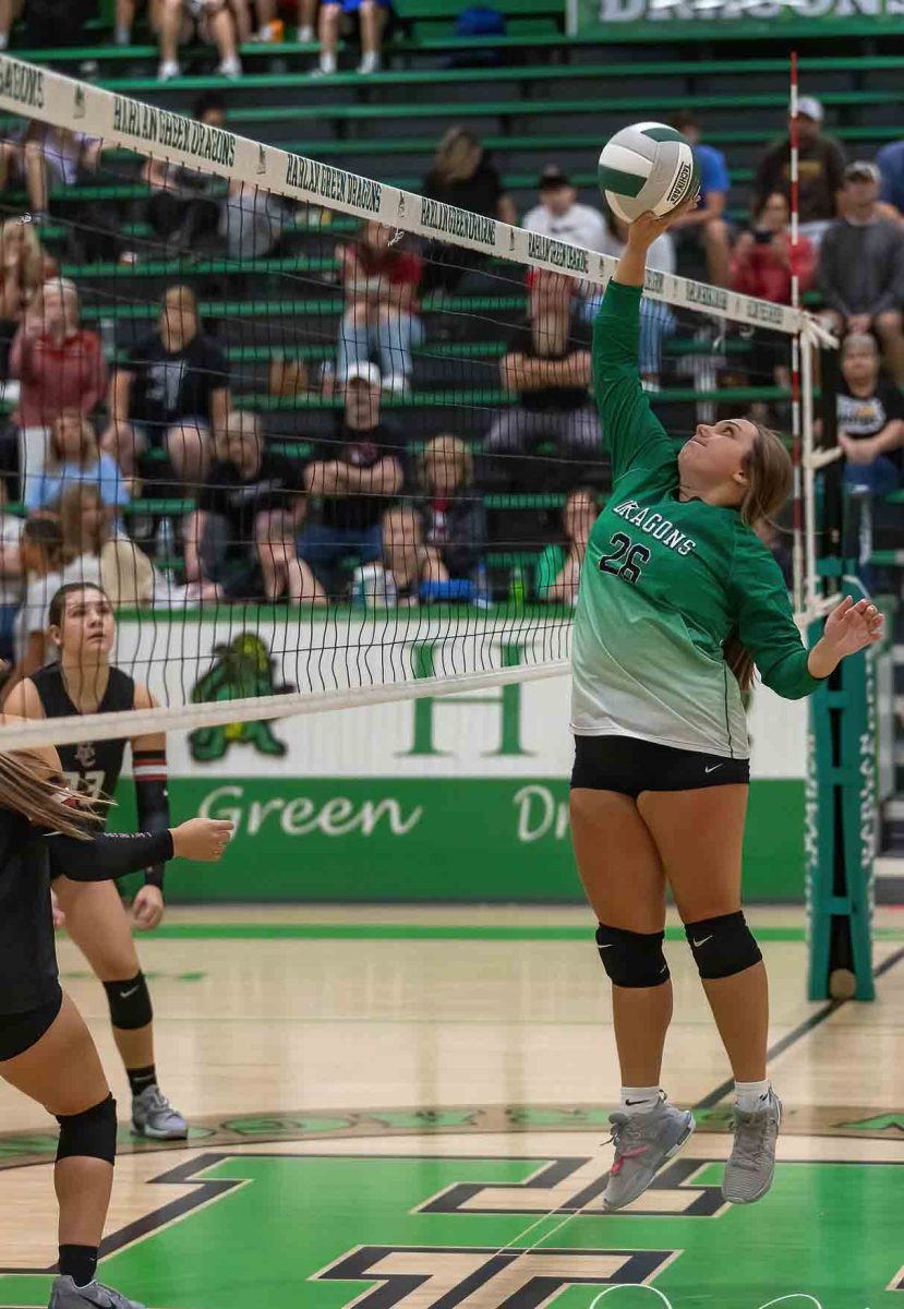 Harlan's Gracie Hensley went to the net for a return in a district match Monday against Harlan County.