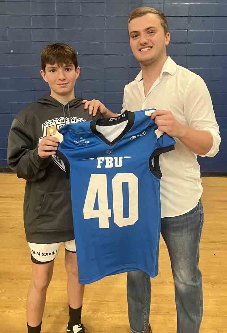 James A. Cawood sixth grader Brantley Burkhart is pictured receiving his Team Kentucky jersey from coach Jack Herron. Team Kentucky recently won the Central regional championship and advanced to the national tournament in Florida.