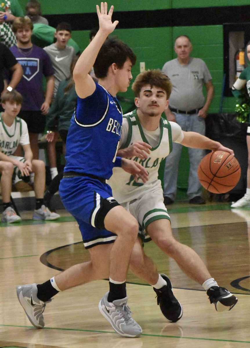 Harlan freshman guard Ethan Huff worked around a Bell County defender on Tuesday. Huff led the Dragons with 15 points in a 76-41 loss.