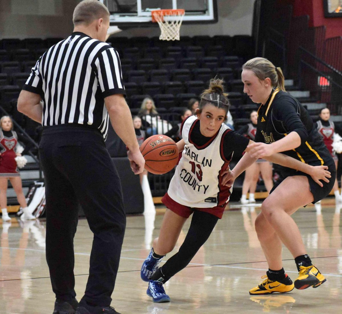 Harlan County freshman guard Jaylee Cochran worked around a Johnson Central defender in Monday's game. The visiting Lady Eagles improved to 6-0 with a 66-32 victory.