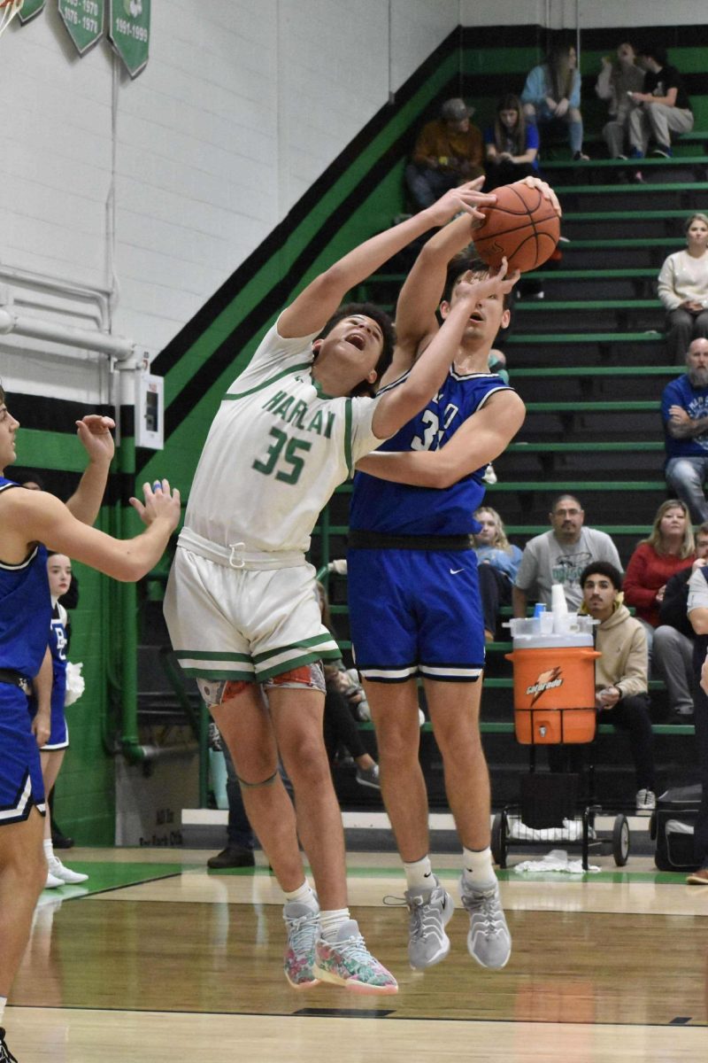 Harlan's Kobe Noe and Bell County's Ethan Buell battled for a rebound in Tuesday's district clash.