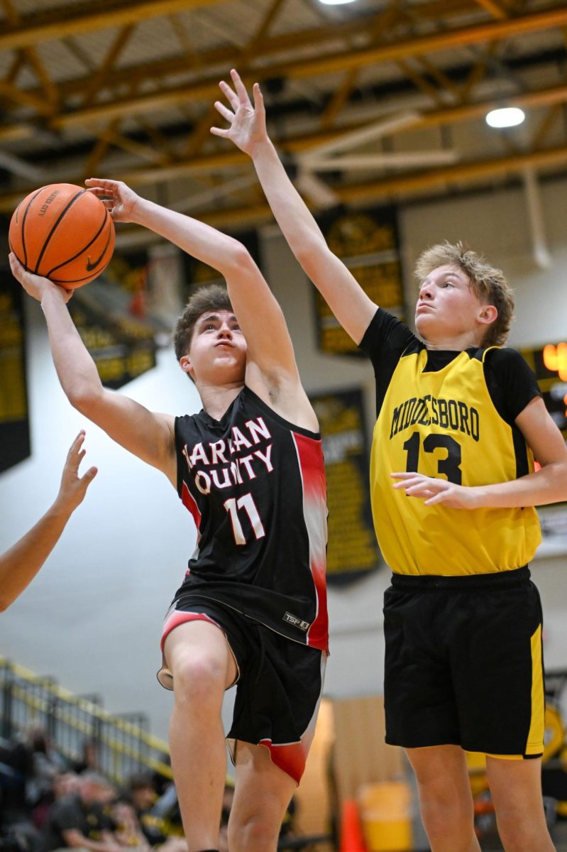 Harlan County forward Hudson Faulkner worked around Middlesboro's Parker Hampton in middle school basketball action Saturday.