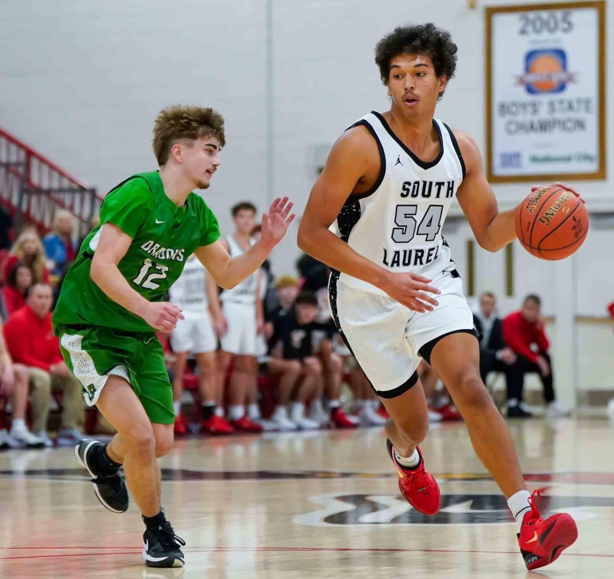 South Laurel senior forward Jordan Mabe worked against Harlan's Ethan Huff in Tuesday's season-opening game in London. Mabe led the Cards with 16 points in a 66-24 win.