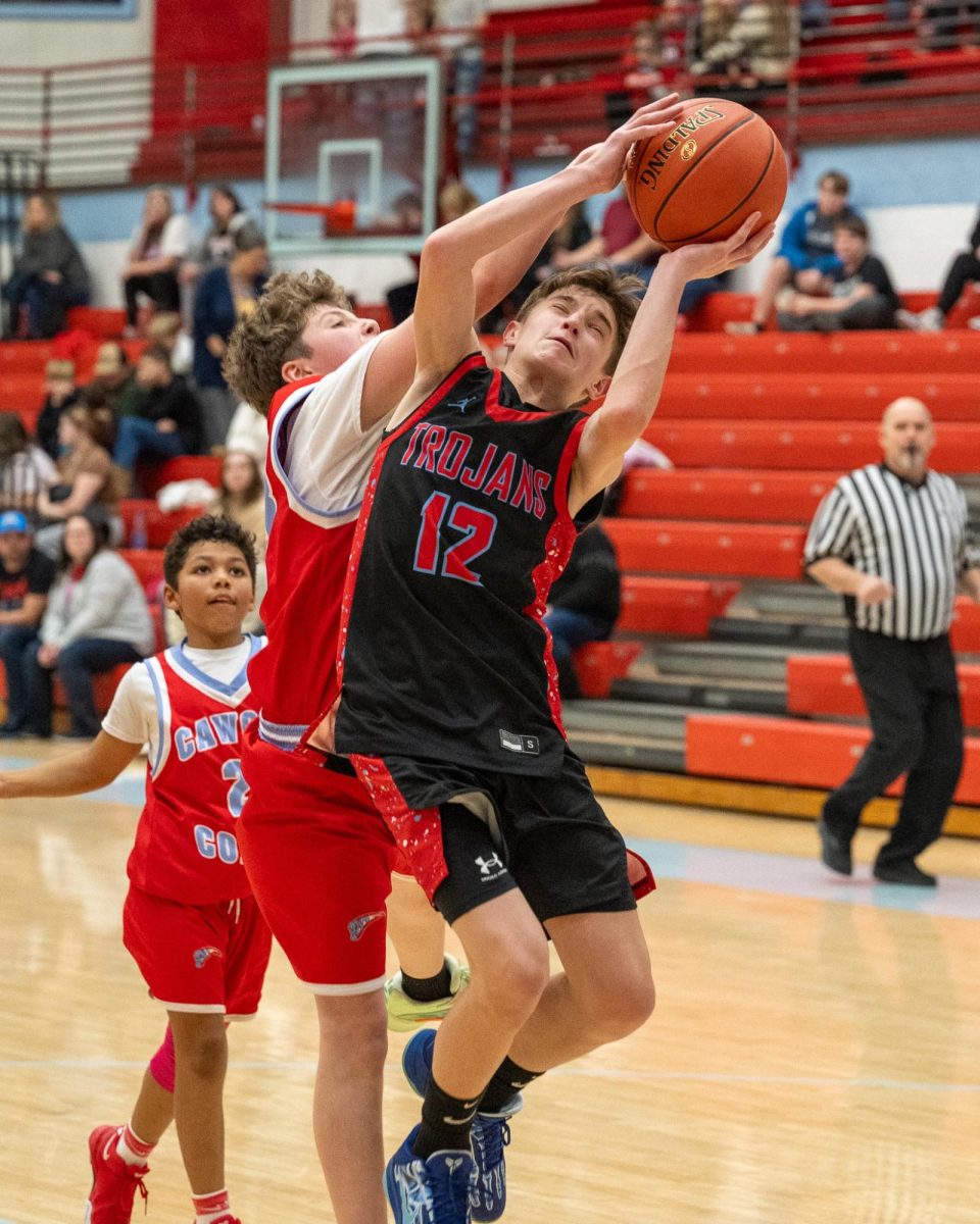 James A. Cawood guard Easton Engle drew a foul in county tournament action Tuesday. Engle scored nine points in the Trojans' 40-3 victory.