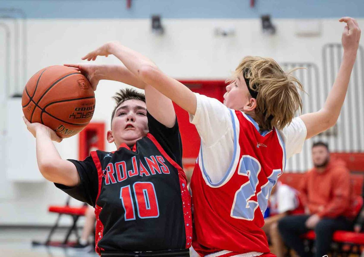 James A. Cawood guard Seth Johnson went up for a shot against Cawood's Shawn Smith in fifth- and sixth-grade basketball action Thursday.