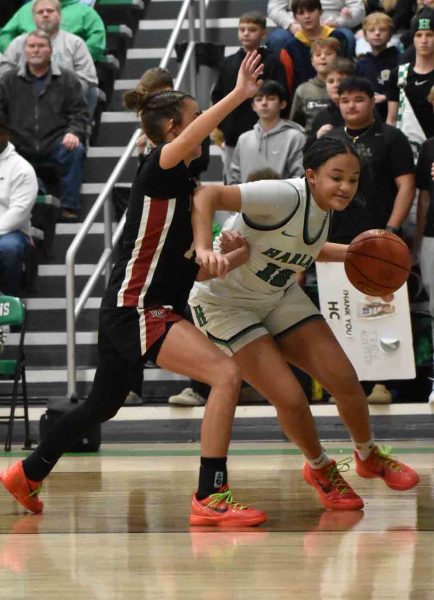 Harlan's Peyshaunce Wynn worked to the basket as Harlan County's Jaylee Cochran defended in Thursday's game. Wynn scored 16 to lead Harlan in a 56-48 victory. Cochran led HCHS with 15 points.