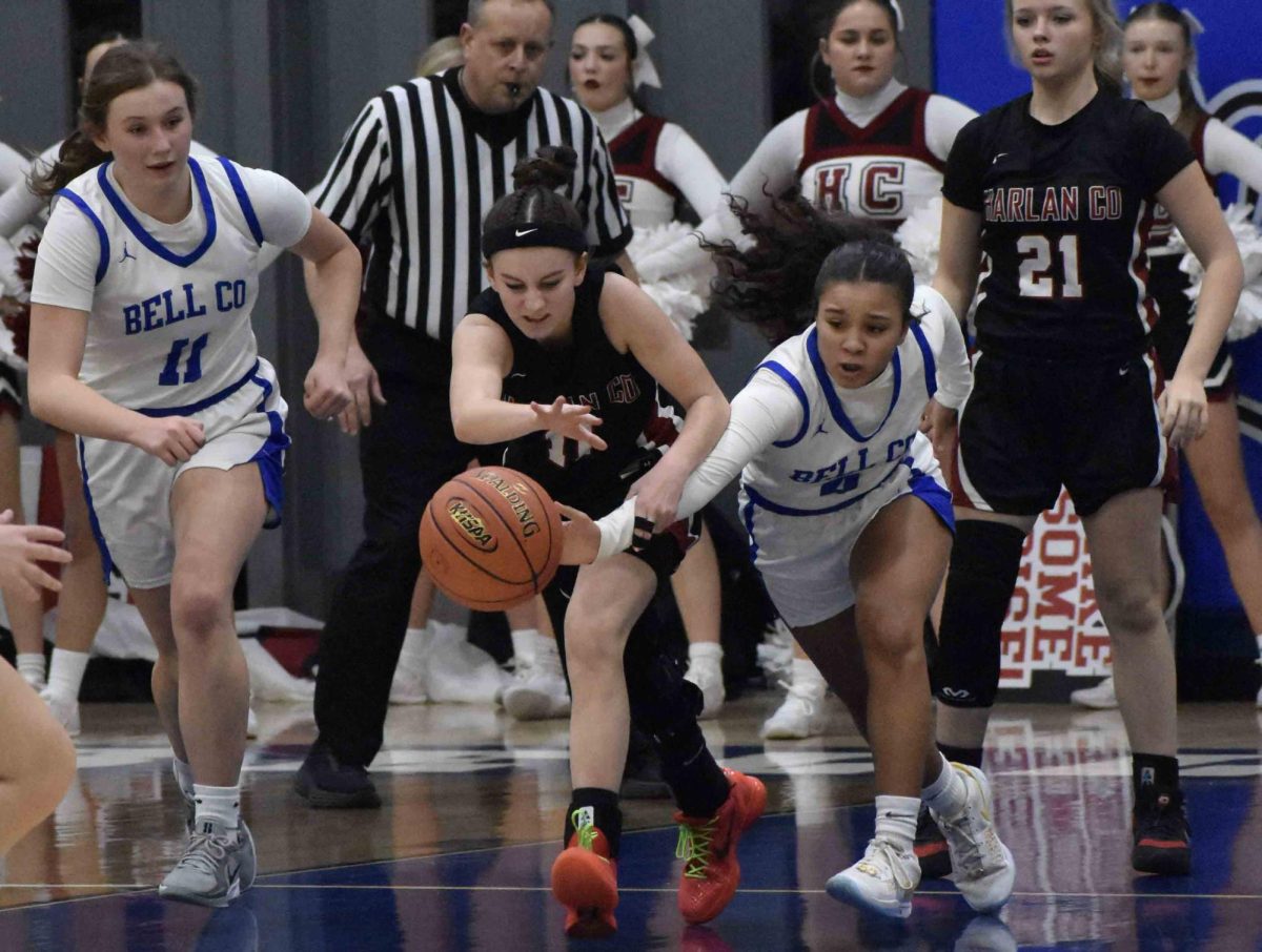 Harlan County's Reagan Clem and Bell County's Lyla Scearse went after a loose ball in Tuesday's district clash at Log Mountain. Bell improved to 3-1 in district action with a 69-33 victory.