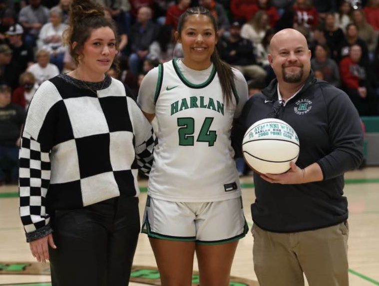 Harlan senior Aymanni Wynn was honored recenlty for becoming third player in Harlan High School history to reach the 2,000-point plateau. She is pictured with coach Mackenzie Varner and principal Mike Bolton.