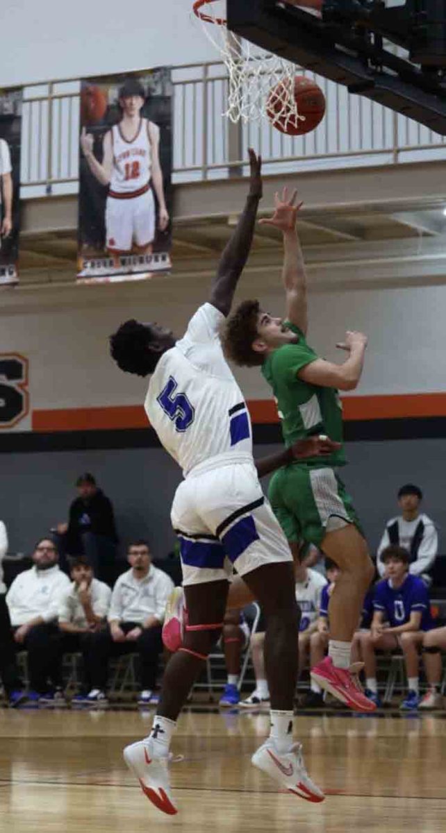 Harlan guard Ethan Huff shot over Oneida Baptist’s Dennis Esemuede in action from the 13th Region All “A” Classic on Saturday. OBI advance with a 61-38 win.