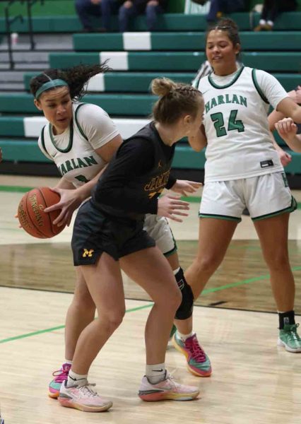 Harlan senior forward Kylie Noe worked around a Middlesboro defender on Friday during the Lady Dragons' 74-49 victory. Noe scored 18 points in the win, surpassing the 2,000-point mark for her career in the process.