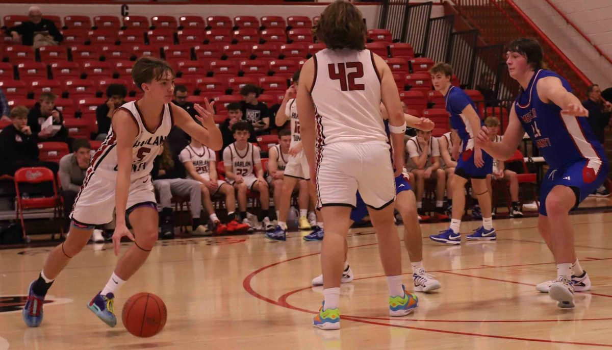 Harlan County junior guard Brennan Blevins worked around a pick from Jaycee Carter in Friday’s game against Mercer County. Blevins hit two 3-pointers in the third quarter and finished with eight points in the Bears’ 70-58 win.
